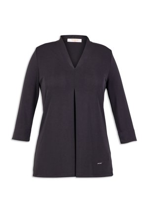 Tunique noire avec un col en V, des manches longues et un pli avant. Tissu doux au toucher lisse. Présente une petite étiquette de marque au bas.