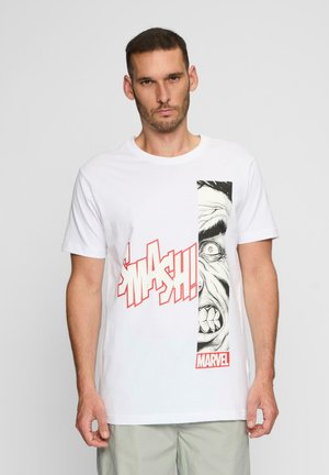 T-shirt en coton blanc avec un graphisme de style bande dessinée représentant un visage et le texte "SMASH !" en rouge. Comprend une étiquette de marque "MARVEL".
