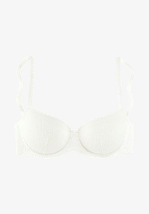 White lace bra with padded cups and adjustable scalloped straps. Features a central bow detail and textured floral pattern on fabric.