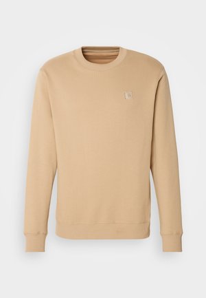 Béžová mikina vyrobená z mäkkého materiálu, s okrúhlym výstrihom, dlhými rukávmi, rebrovanými manžetami a minimálnym výšivom loga na hrudi.