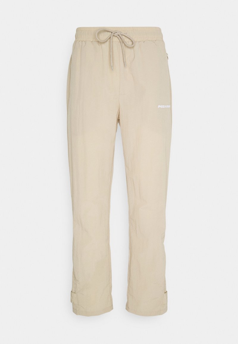 Beige lehké kalhoty s elastickým pasem, nastavitelnou šňůrkou, bočními kapsami a bílým potiskem loga na nohavici.