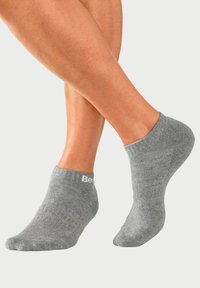 Gray ankle socks made of soft, stretchy material; feature a ribbed cuff and discreet logo on one side.