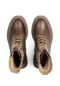 Stivali ankle in pelle marrone con accenti beige, con lacci frontali e cerniere laterali. Presentano una suola testurizzata e una punta arrotondata.