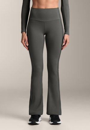 Sötét szürke, magas derekú, trapéz fazonú leggings, sima anyagból, kontrasztos oldalsó varrással és széles derékgummival a kényelem érdekében.