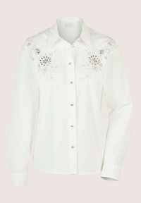 Witte blouse met lange mouwen, van een gestructureerde stof, versierd met bloemborduurwerk en pailletten op de schouders. Zilveren knopen.