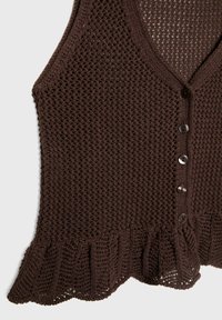 Brązowa dziergana kamizelka z otwartym wzorem, wyposażona w pię�ć ciemnych guzików z przodu oraz falbaniany brzeg na dole.