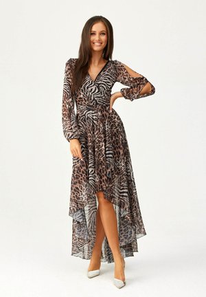 Long, flowy dress in sheer fabric featuring a mixed leopard and zebra print in shades of brown and black. High-low hem and cold-shoulder design.