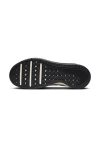 Black rubber shoe sole with textured grip pattern and white accent grooves; curved shape with a slight arch and reinforced heel area.