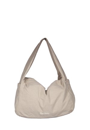 Sac à épaule en tissu beige avec larges bretelles et fermeture éclair, présentant un discret logo "Craie Studio" à l'avant.