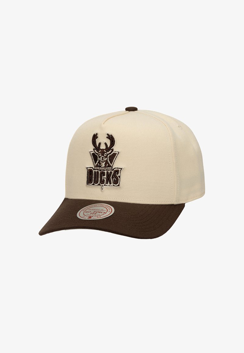 Cream-colored cap with a brown visor, featuring an embroidered Milwaukee Bucks logo with antlers and text. Made from structured fabric.