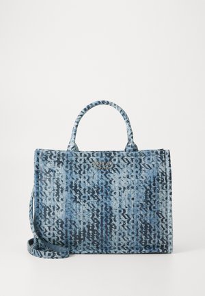 Denim tote bag in blue with a textured pattern, dual handles, and a detachable shoulder strap. Features a logo accent.