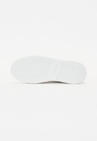 White rubber shoe sole featuring a textured surface with circular patterns and a flat profile, labeled with brand name “Gabor.”