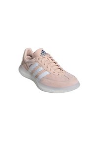 Baskets Adidas rose clair avec des rayures blanches, texte "Spezial" sur le côté, design à lacets et semelle translucide texturée.