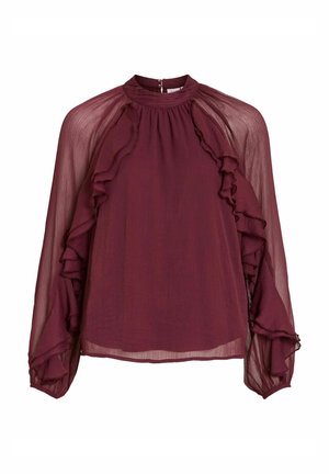 Bordeaux bluse med lange, gennemsigtige ærmer, flæsedetaljer langs halsudskæringen og ærmerne, samt et højt halsdesign. Lukning med knap bagpå.