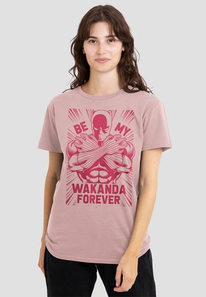Light pink cotton t-shirt featuring a graphic print of a muscular figure with crossed arms and text “BE MY WAKANDA FOREVER” in red.