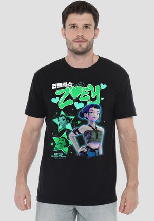 Man wearing black T-shirt featuring animated female character with blue hair, green hearts, and text "Zvey" and "KPOP Demon Hunters."