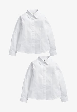Bela srajca s gumbom, ki ima klasičen ovratnik, dolge rokave in vertikalne šive. Izdelana iz gladkega, lahkega materiala.