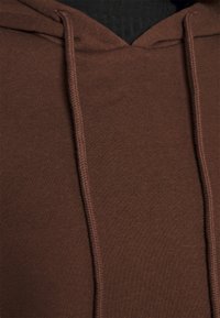 Brown hoodie with a soft texture, featuring a drawstring hood, a kangaroo pocket, and standard stitching details.
