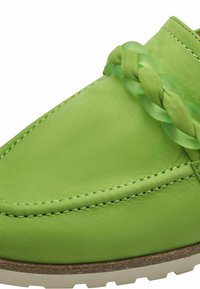 Groene leren instapper met een gevlochten transparante accente. Glad oppervlak en contrasterende stiksels op de bovenkant; lichtgekleurde zool.