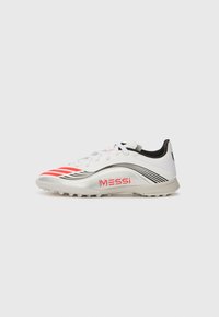 White soccer cleat with red stripes and black accents. Features a shiny silver detailing and "MESSi" branding on the side.