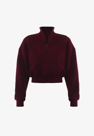 Burgundowa cropped bluza z wysokim kołnierzem, pół-zamkiem i prążkowanymi mankietami. Miękka tekstura i luźny krój, idealne do warstwowego noszenia.