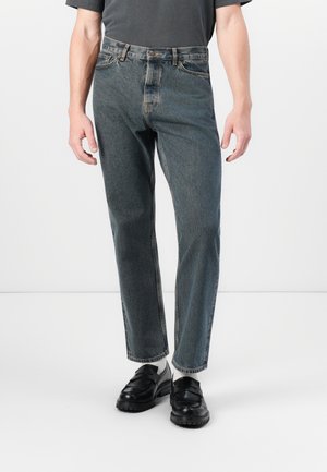 Skinny jeans in dark blue denim, featuring a classic five-pocket design and subtle fading. Finished with a button closure and belt loops.