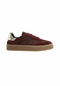 Burgundy sneaker with textured suede upper, black accent stripes, and metallic silver heel. Features a thick, translucent rubber sole.