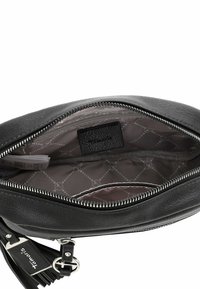 Black leather handbag with a zip closure, featuring a textured exterior and lined interior with a subtle pattern. Includes a brand label inside.