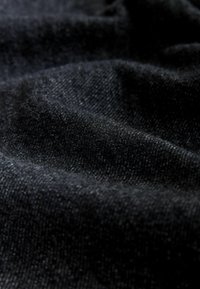 Black fabric with a textured weave, showcasing soft folds and slight sheen. Smooth surface with subtle variations in depth and light.