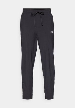 Black track pants made of lightweight material with an elastic waistband and adjustable drawstring. Features a small logo on the side.