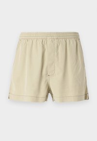 Beige Shorts aus leichtem Material mit elastischem Bund, flacher Vorderseite und Seitennähten. Sie verfügen über eine subtile Textur und keine Taschen.