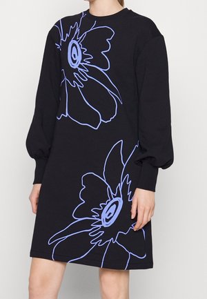Schwarzes Langarmkleid mit Puffärmeln und großen abstrakten Umrissen von hellvioletten Blumen auf der Vorderseite, getragen von einer Person mit entspanntem Arm.