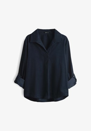 Blouse à manches longues bleu foncé avec des poignets boutonnés repliés, un col large et un décolleté en V sur fond blanc.