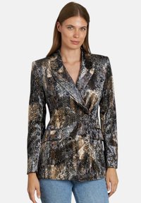 Blazer de estampado de serpiente metálico que presenta un diseño de doble botonadura, collar con solapas y dos bolsillos frontales, con un acabado brillante en tonos marrones y negros.