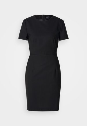 Svart tettsittende kjole med korte ermer, rund halslinje og glidelås bak. Laget av glatt stoff med en subtil glans og definert midje.