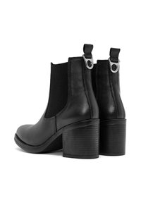 Stivaletti neri in pelle con pannelli laterali elastici, punta rotonda e tacco largo. Presentano una linguetta con una accentatura in metallo.