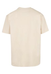 Beige t-shirt made of soft cotton, featuring a rounded neckline and short sleeves. The back is plain without any graphics or patterns.