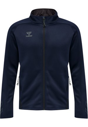 Marinblaue Zip-Jacke aus weichem Stoff, mit hohem Kragen, Seitentaschen mit Reißverschluss und kantigen Akzentmustern an den Ärmeln.