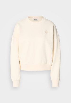 Kremfarget croppet sweatshirt med rund hals, ribbestrikkede mansjetter og en subtil brodert logo på brystet. Myk tekstur.