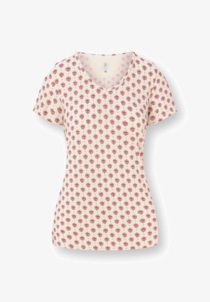 Cream short-sleeve V-neck shirt with repeating red floral pattern, fitted waist, and soft fabric texture.
