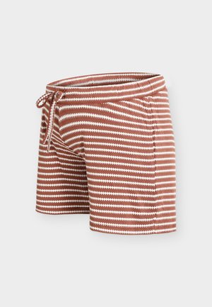 Brune og hvide strikkede shorts med zigzagmønster og snøre i taljen, vist mod en ensfarvet baggrund.