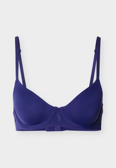 Σουτιέν με καλούπι σε ναυτικό μπλε, με ρυθμιζόμενους ιμάντες και διακριτικό μπανέλα, διακοσμημένο με μικρό ανάγλυφο λογότυπο στο κέντρο στο μπροστινό μέρος.