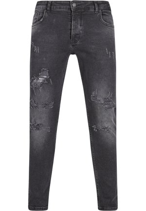 Jeans in denim nero con una vestibilità slim, caratterizzati da dettagli strappati, texture sbiadita e un classico design a cinque tasche. Chiusura con bottone in vita.