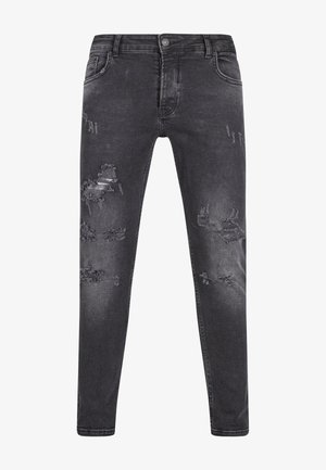 Mustad teksased kitsas lõikega, millel on rebenenud detailid, kulunud tekstuur ja klassikaline viie tasku disain. Nööpiga kinnitamine vöö kohal.