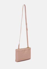 Pink quilted handbag with a long adjustable strap, featuring a gold zipper and smooth texture. Compact rectangular shape, minimal detailing.
