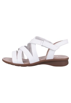 Witte leren sandaal met drie voorste bandjes, verstelbare enkelband, gewatteerde voetbed en lage bruine sleehakzool.