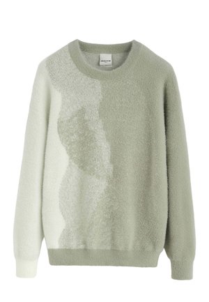 Pull vert clair texturé avec un col rond et des manches longues. Présente un motif dégradé qui passe d'un uni à un effet moucheté. Matière douce.