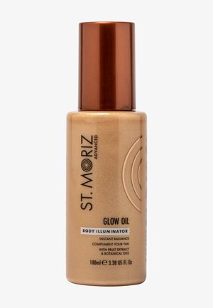 Flacon illuminant corps St. Moriz Advanced Glow Oil avec un bouchon bronze, étiqueté 100ml, offrant une radiance instantanée et des huiles botaniques.