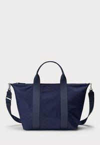 Navy blue tote bag with dual handles, adjustable shoulder strap, top zipper, and small centered logo on front.