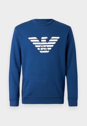 Blue sweatshirt made of cotton, featuring a white striped eagle logo with "GA" in the center. Round neckline and long sleeves.